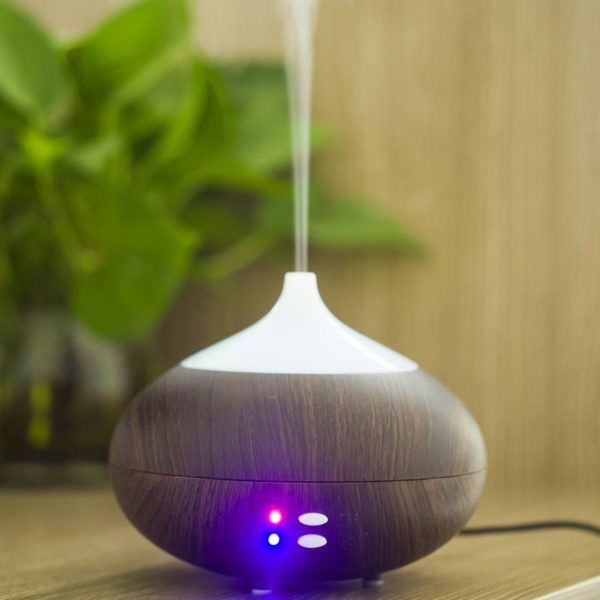 Wooden style vase aroma diffuser on wooden table